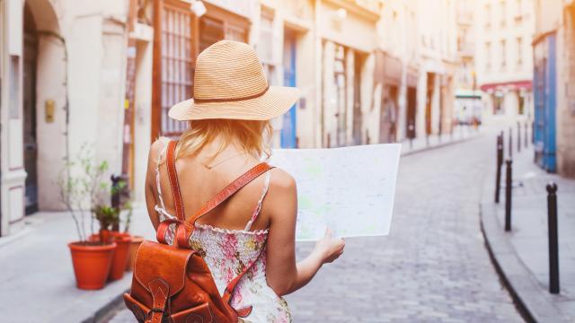 woman tourist looking at the map on the street of european city, travel to Europe